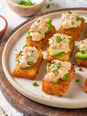 Plate of crispy rice cakes topped with creamy vegan tuna