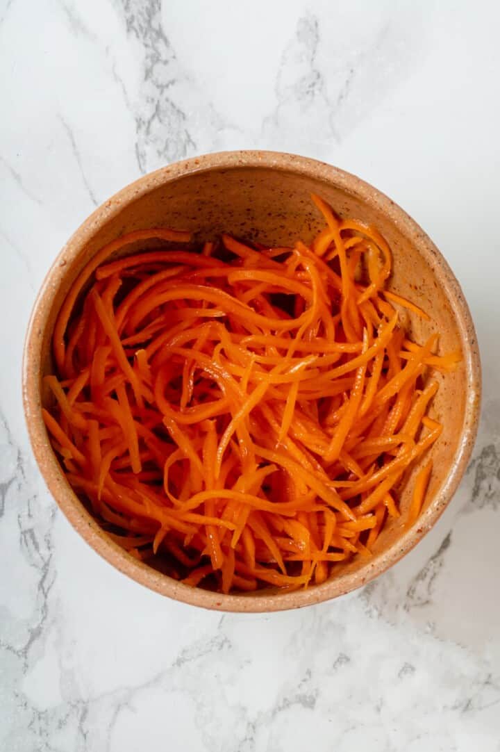 Overhead view of spicy carrot salad in bowl