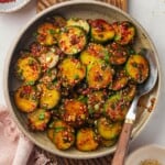 Overhead view of Korean cucumber salad in bowl with spoon