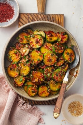 Overhead view of Korean cucumber salad in bowl with spoon