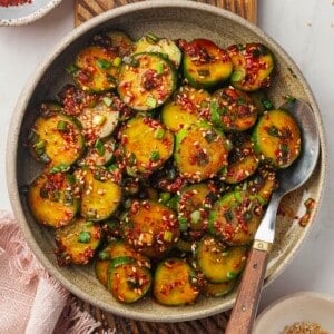 Overhead view of Korean cucumber salad in bowl with spoon