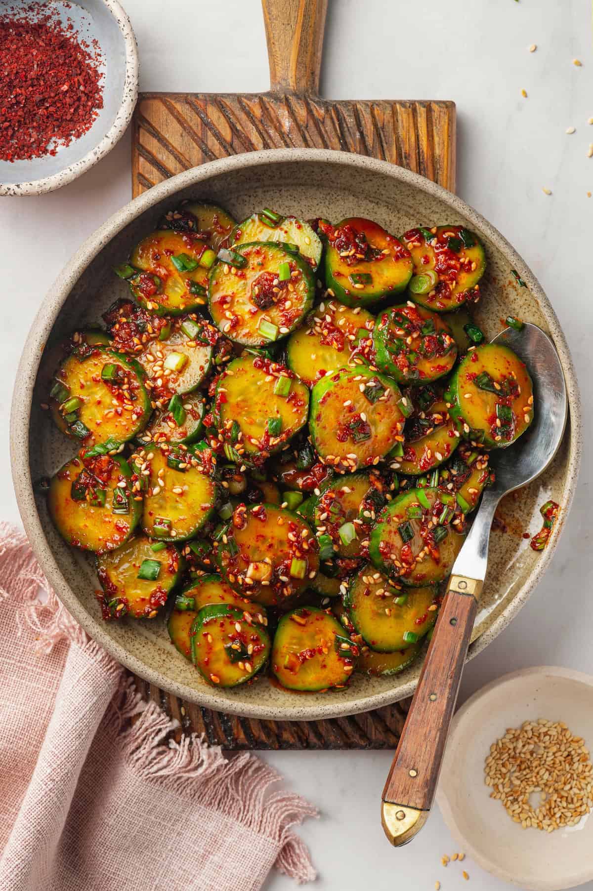 Crisp, refreshing, and full of bold flavour, this spicy Korean cucumber salad recipe is an easy side dish you’ll make all summer long! Overhead view of Korean cucumber salad in bowl with spoon