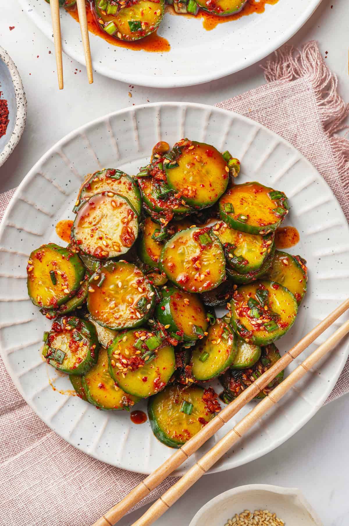 Overhead view of Korean cucumber salad on plate with chopsticks
