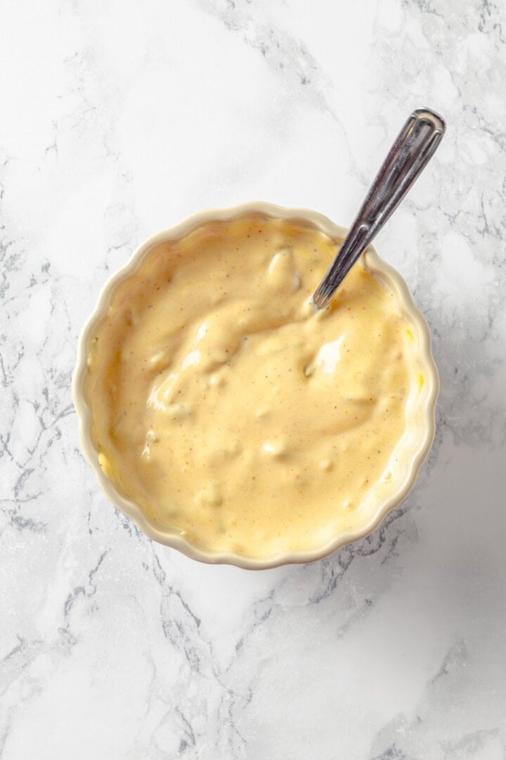 This easy burger sauce is made with pantry staples, which means you can mix it up anytime you need it for burgers, fries, wings and more! Overhead view of burger sauce in bowl with spoon