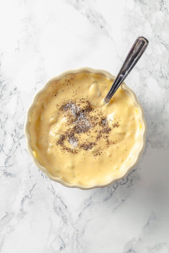 This easy burger sauce is made with pantry staples, which means you can mix it up anytime you need it for burgers, fries, wings and more! Overhead view of salt and pepper added to bowl of burger sauce