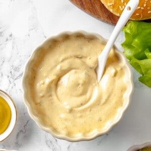 Overhead view of burger sauce in bowl with spoon