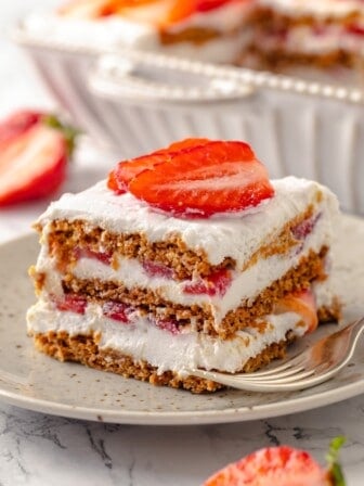 Slice of strawberry icebox cake on plate with fork