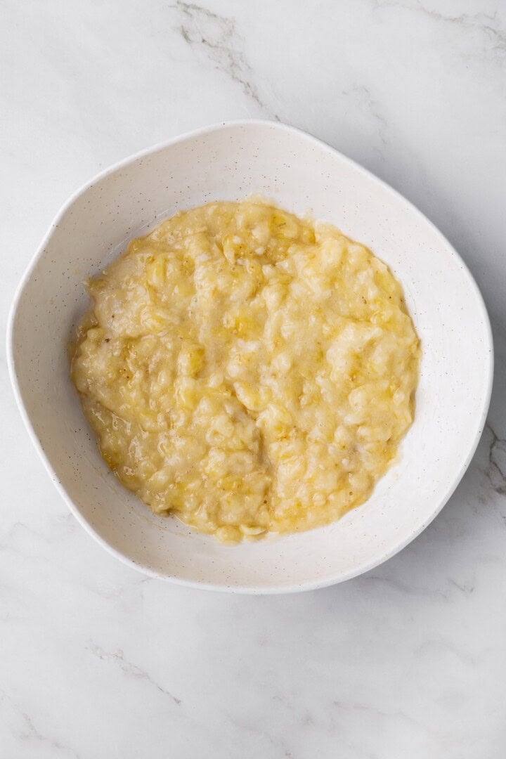 Overhead view of mashed banana in bowl