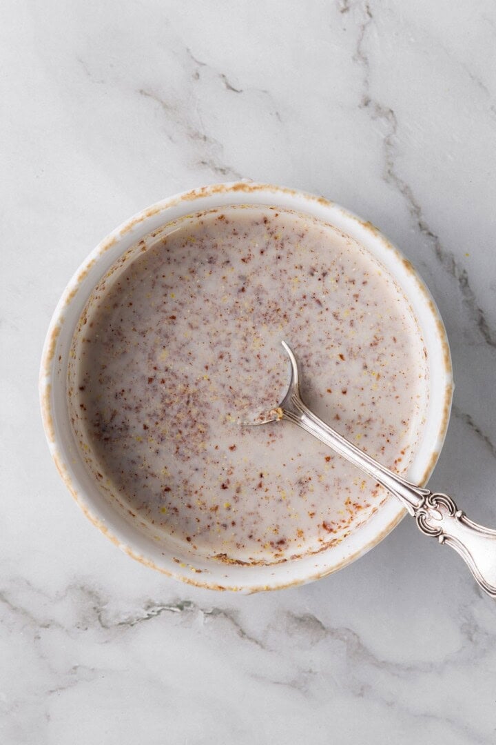 Overhead view of flax egg mixture in bowl with spoon