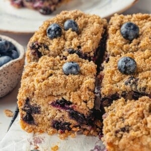 Sliced blueberry buckle on parchment paper