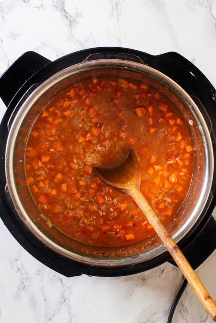 Overhead view of liquid and rice added to Instant Pot for Mexican rice