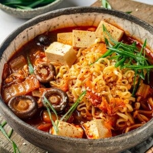 Bowl of kimchi ramen with tofu and shiitake mushrooms