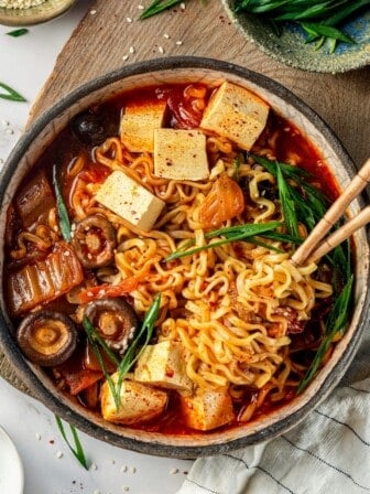 Overhead view of kimchi ramen in bowl with chopsticks