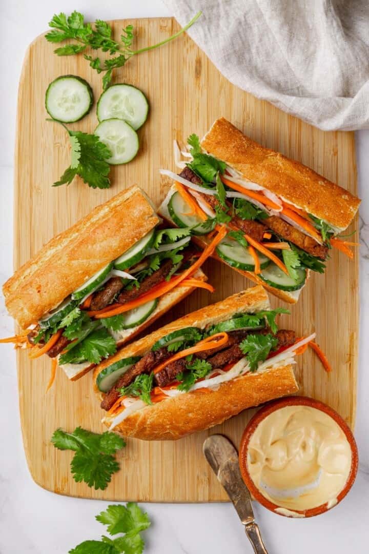 3 vegan banh mi with tofu on cutting board