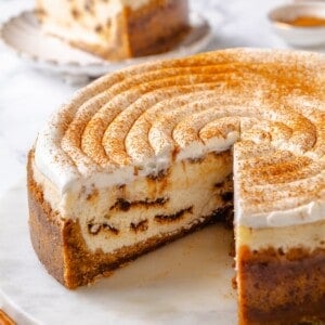 Vegan cinnamon roll cheesecake with slices removed to show inside