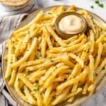 Platter of vegan garlic fries with bowl of aioli