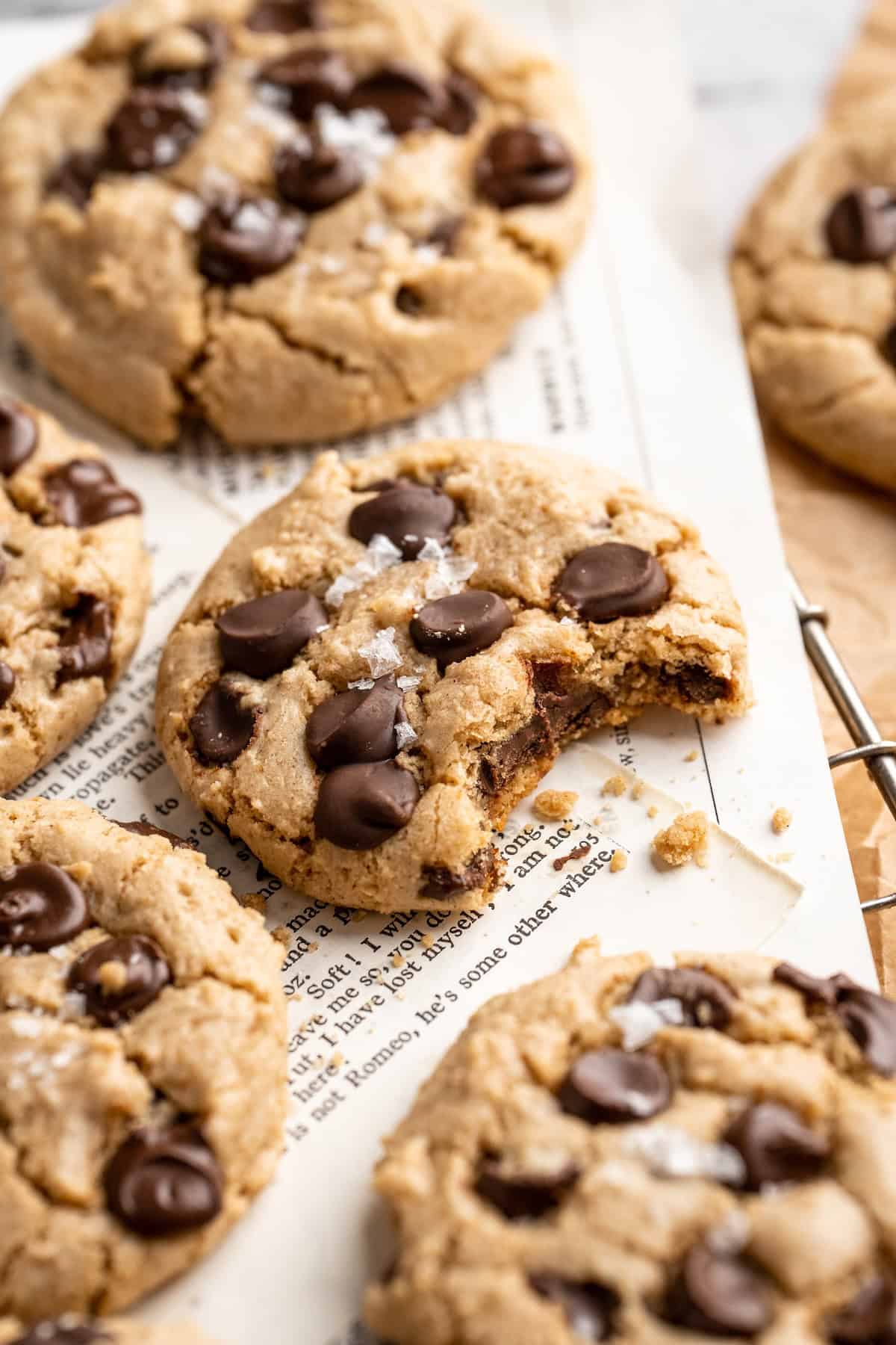 Tahini chocolate chip cookies, one with a bite taken out.
