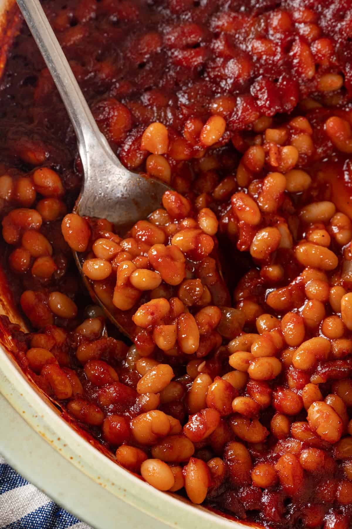 Spoonful of baked beans in pot
