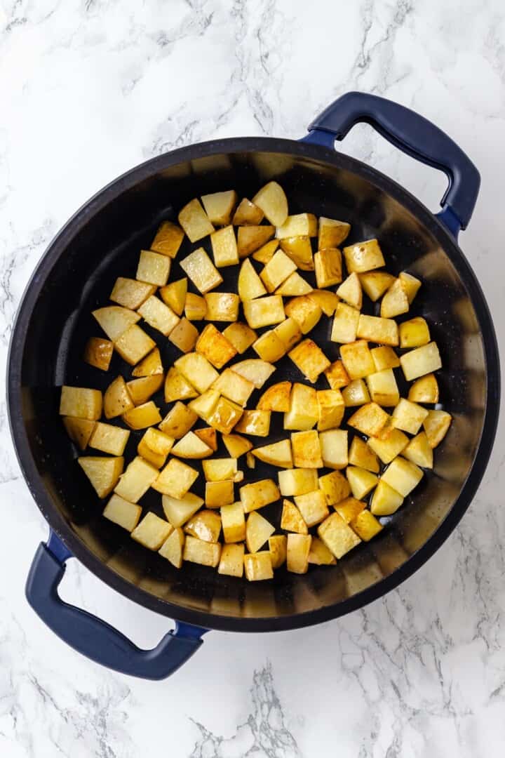 Overhead view of potatoes cooked in skillet