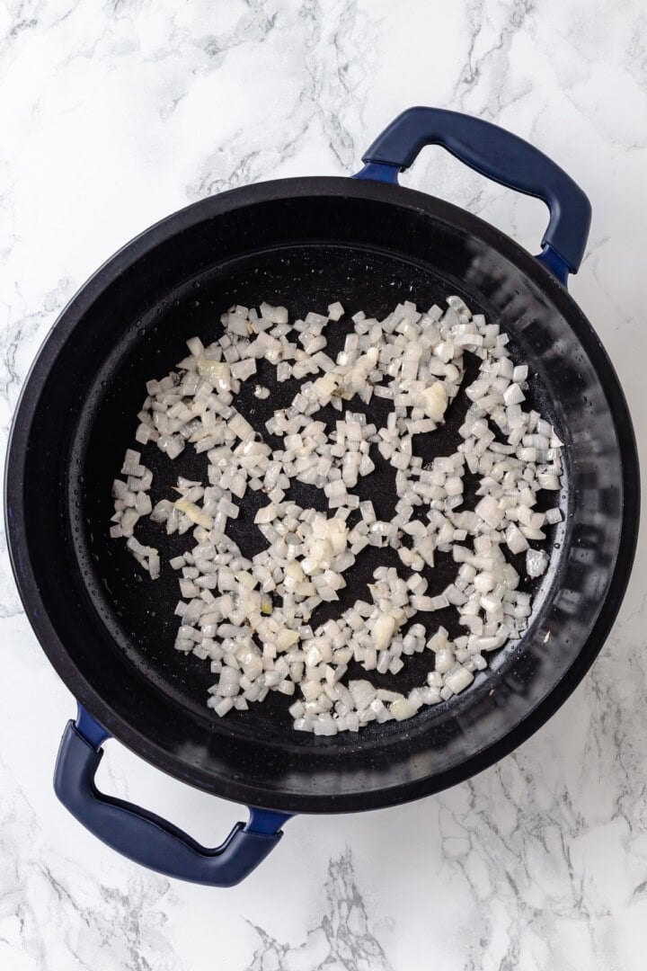 Overhead view of onions cooked in skillet