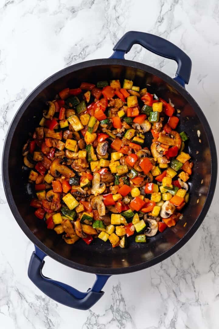 Overhead view of vegetables cooked in cast iron skillet