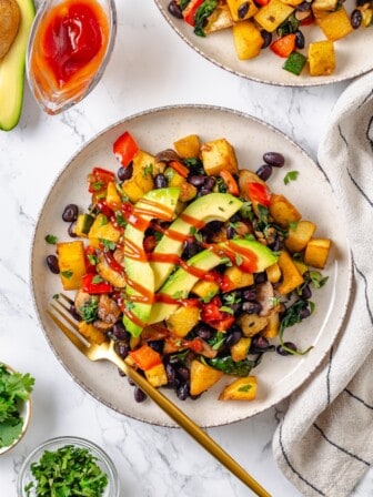 Overhead view of vegan breakfast hash on plate with fork