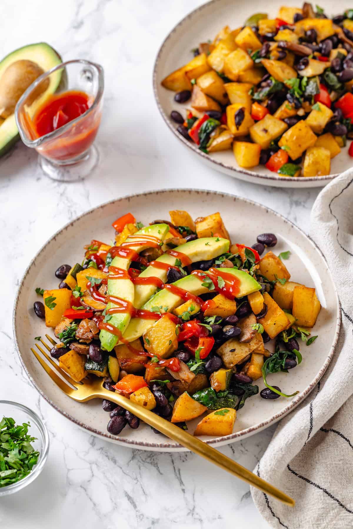 Two plates of vegan breakfast hash