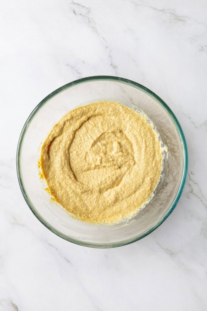 Overhead view of tofu egg mixture in glass bowl