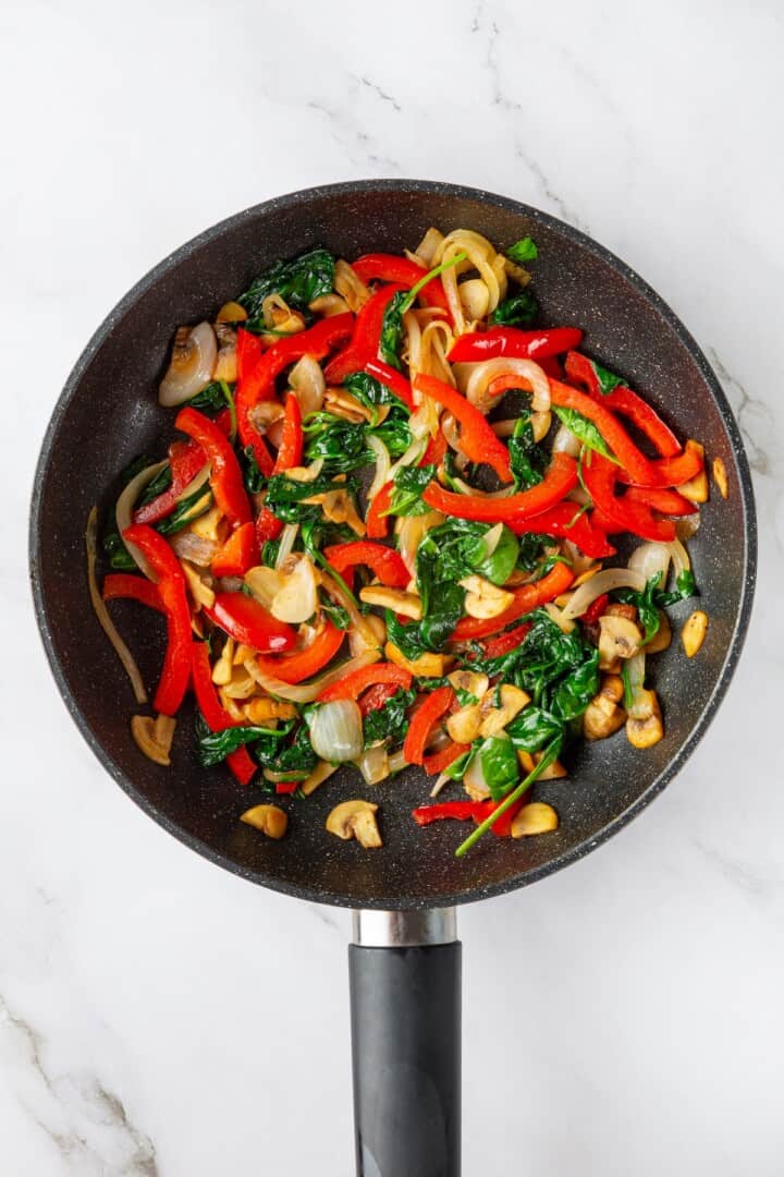 Overhead view of vegetables cooked in skillet