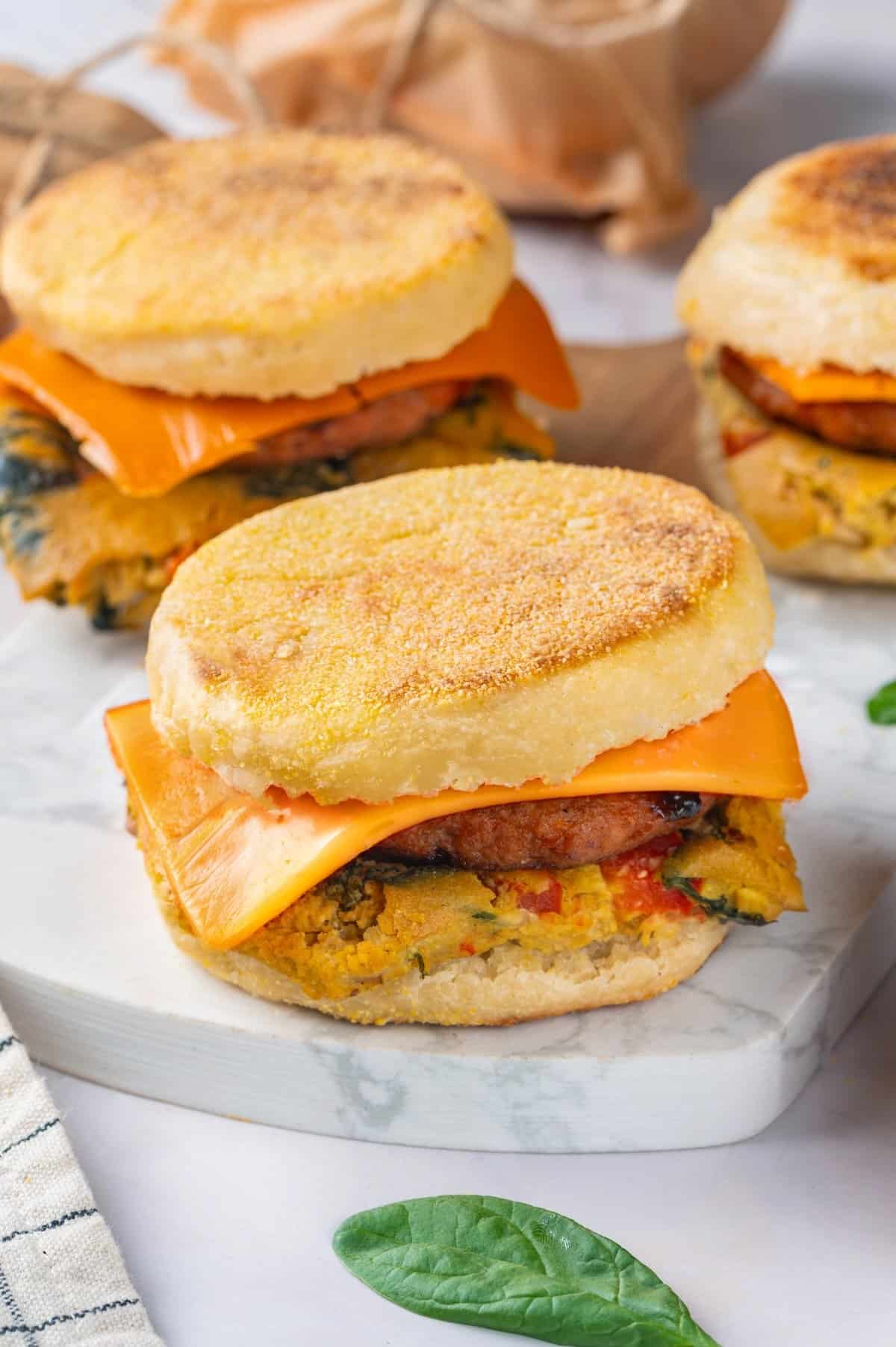 3 vegan breakfast sandwiches on marble slab