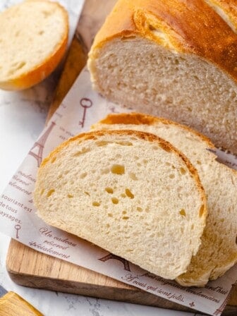 Two slices of French bread cut from loaf on board
