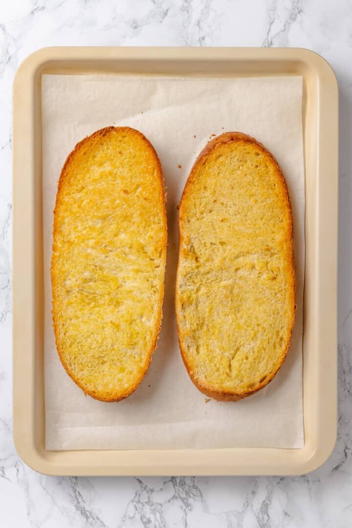 Overhead view of two toasted French bread loaf halves