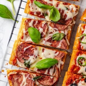 Overhead view of sliced vegan French bread pizza on wire rack