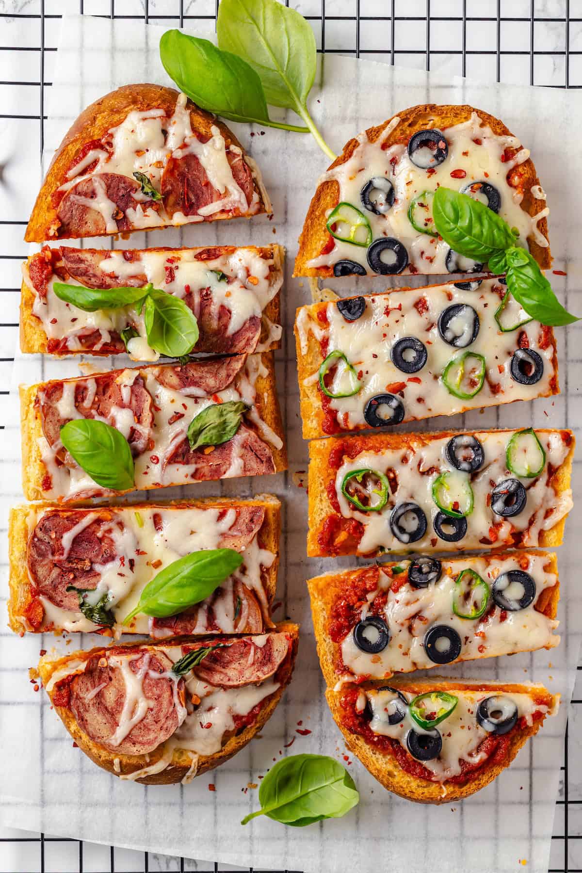 Overhead view of 2 vegan French bread pizzas on wire rack
