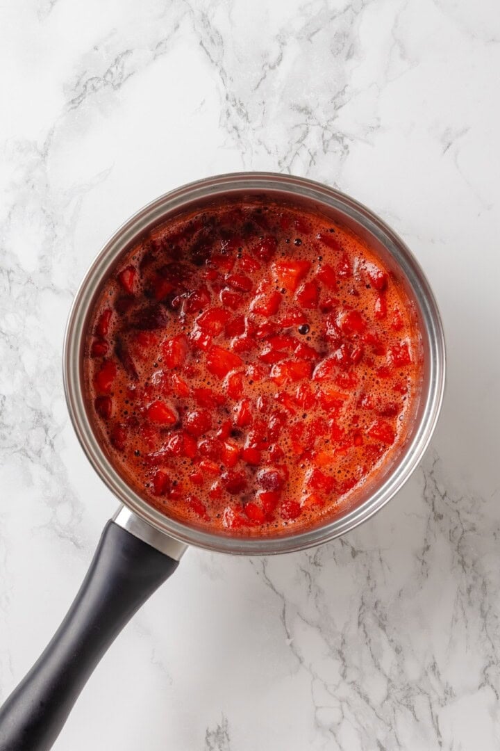Overhead view of strawberry filling cooking in pan