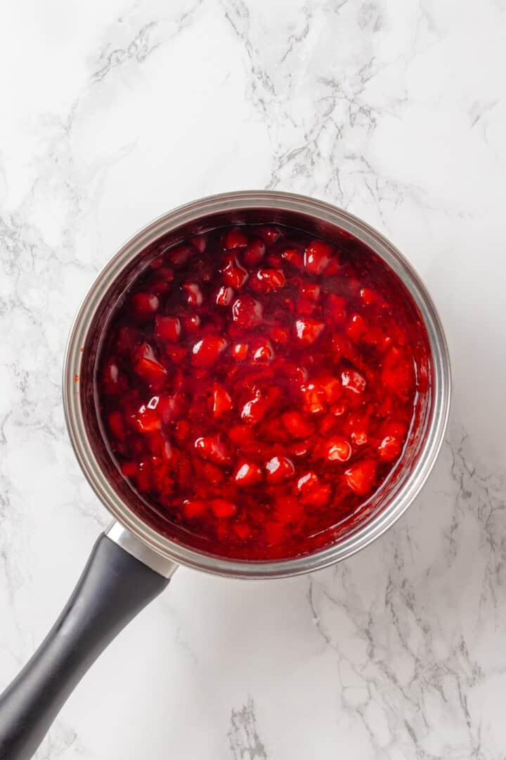 Overhead view of strawberry cake filling in pan