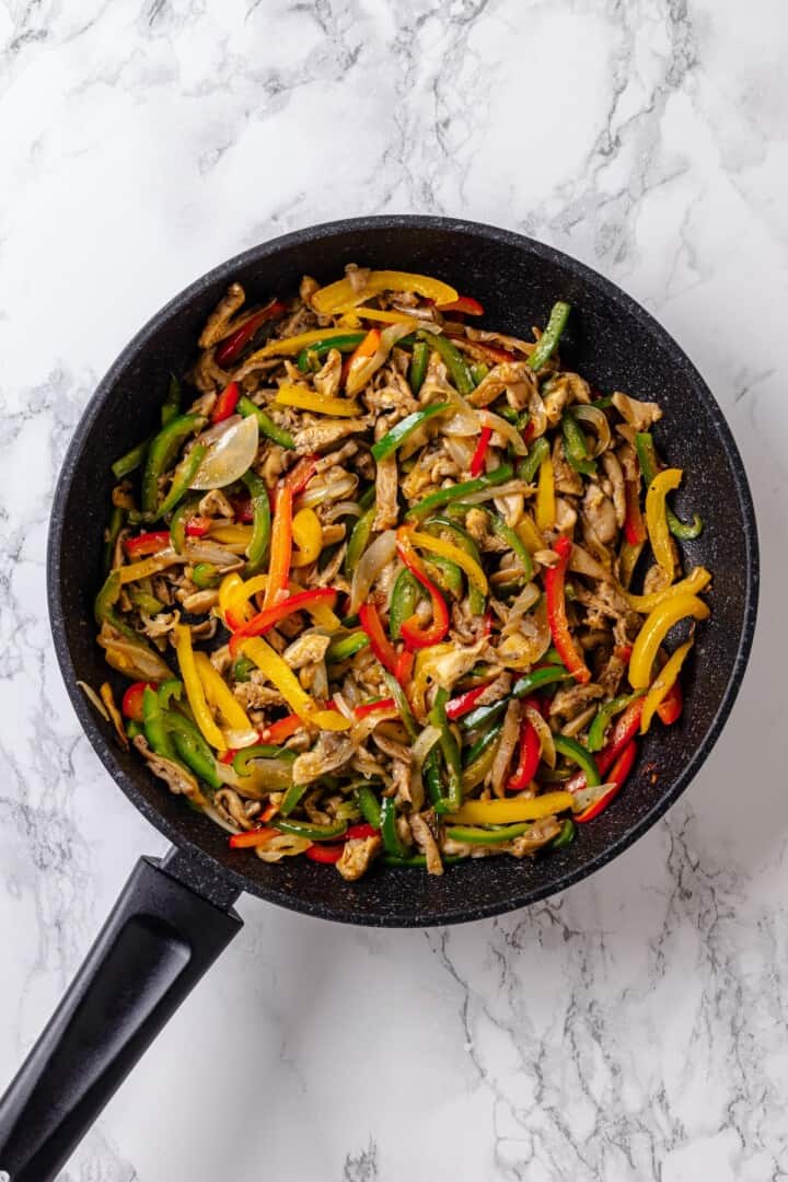 These crispy Tofu Tacos are topped with meaty fajita mushrooms and veggies for a vegan taco recipe that’s satisfying and delicious! Mushroom fajitas in skillet