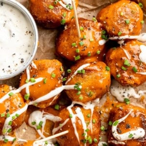 Sheet pan with Buffalo cauliflower meatballs and vegan ranch.