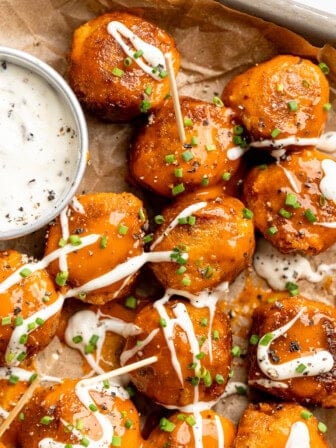 Sheet pan with Buffalo cauliflower meatballs and vegan ranch.