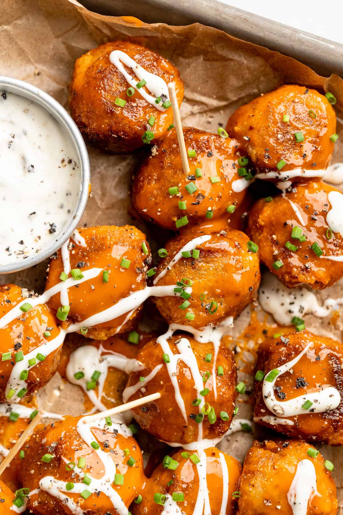 Sheet pan with Buffalo cauliflower meatballs and vegan ranch.