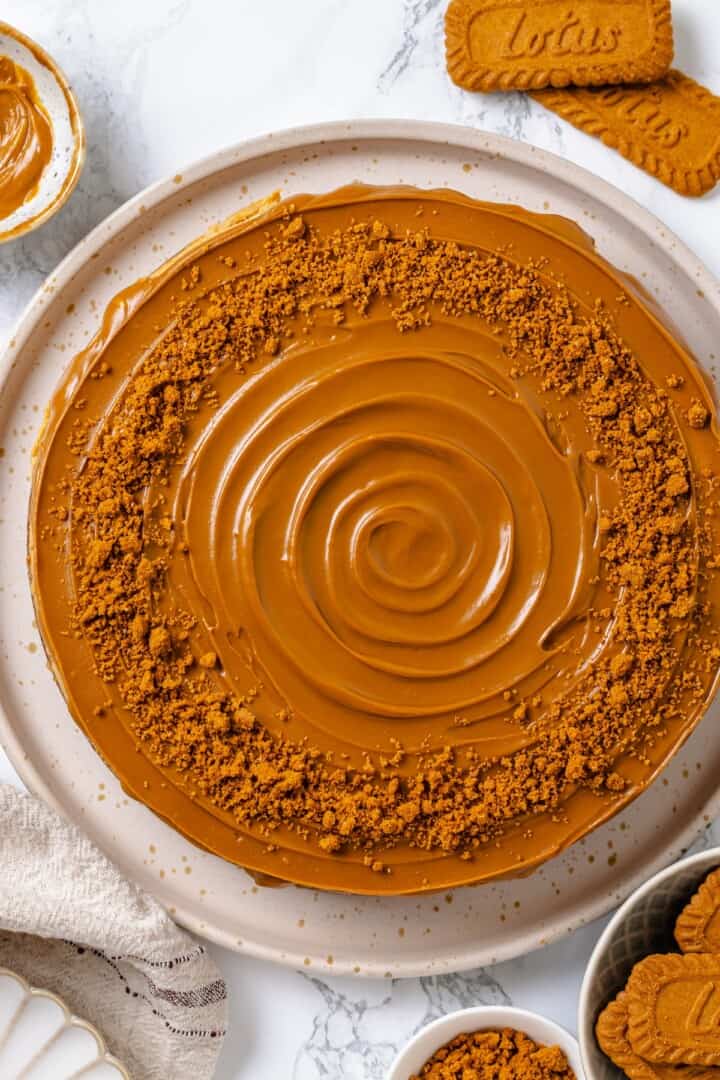 Vegan Biscoff cheesecake decorated with cookie crumbs.