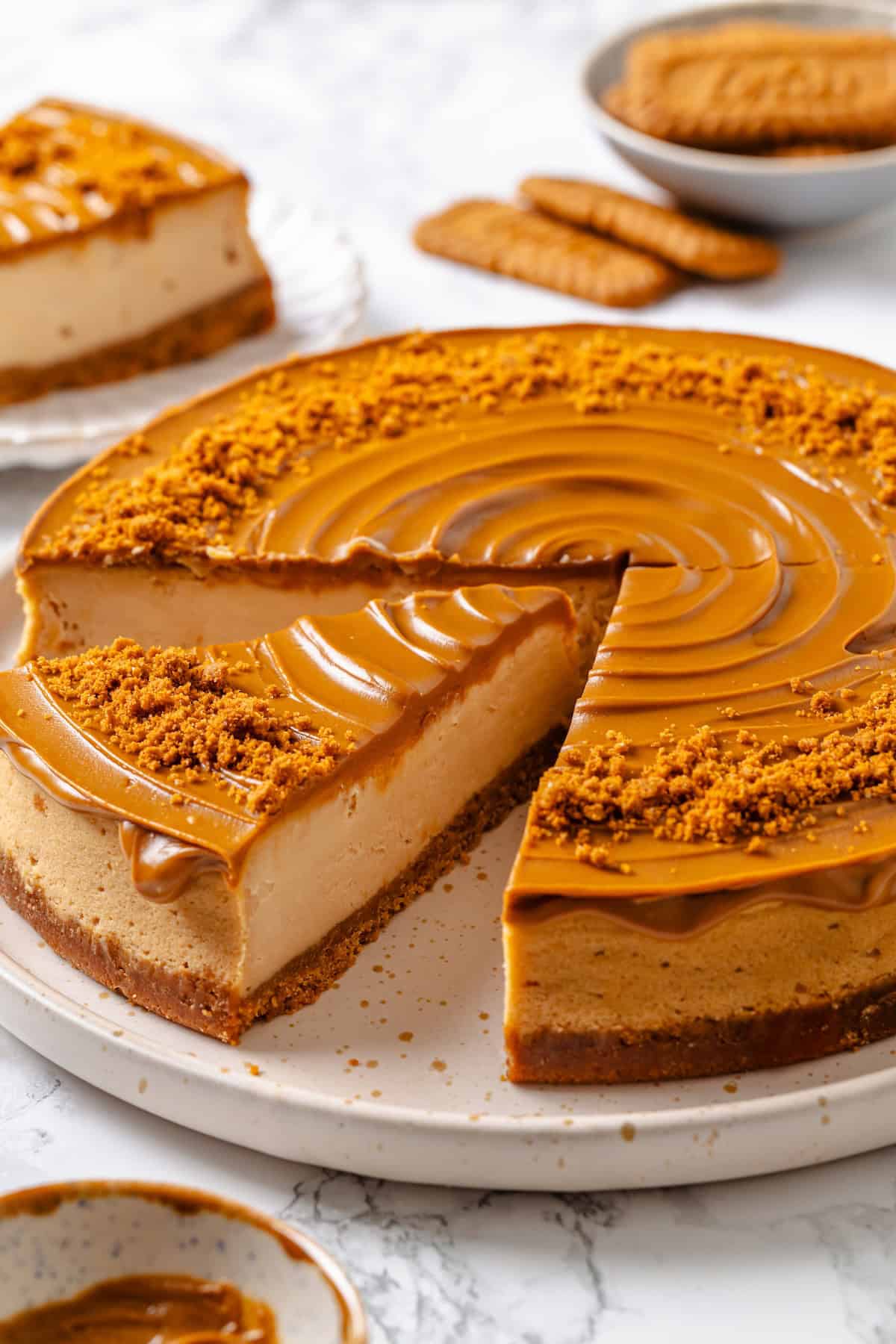 Slice of Biscoff cheesecake cut from rest of cake.