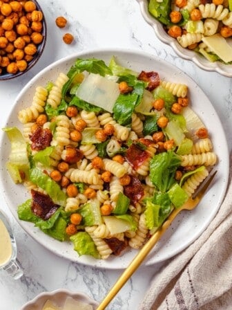 Caesar pasta salad on plate with fork.