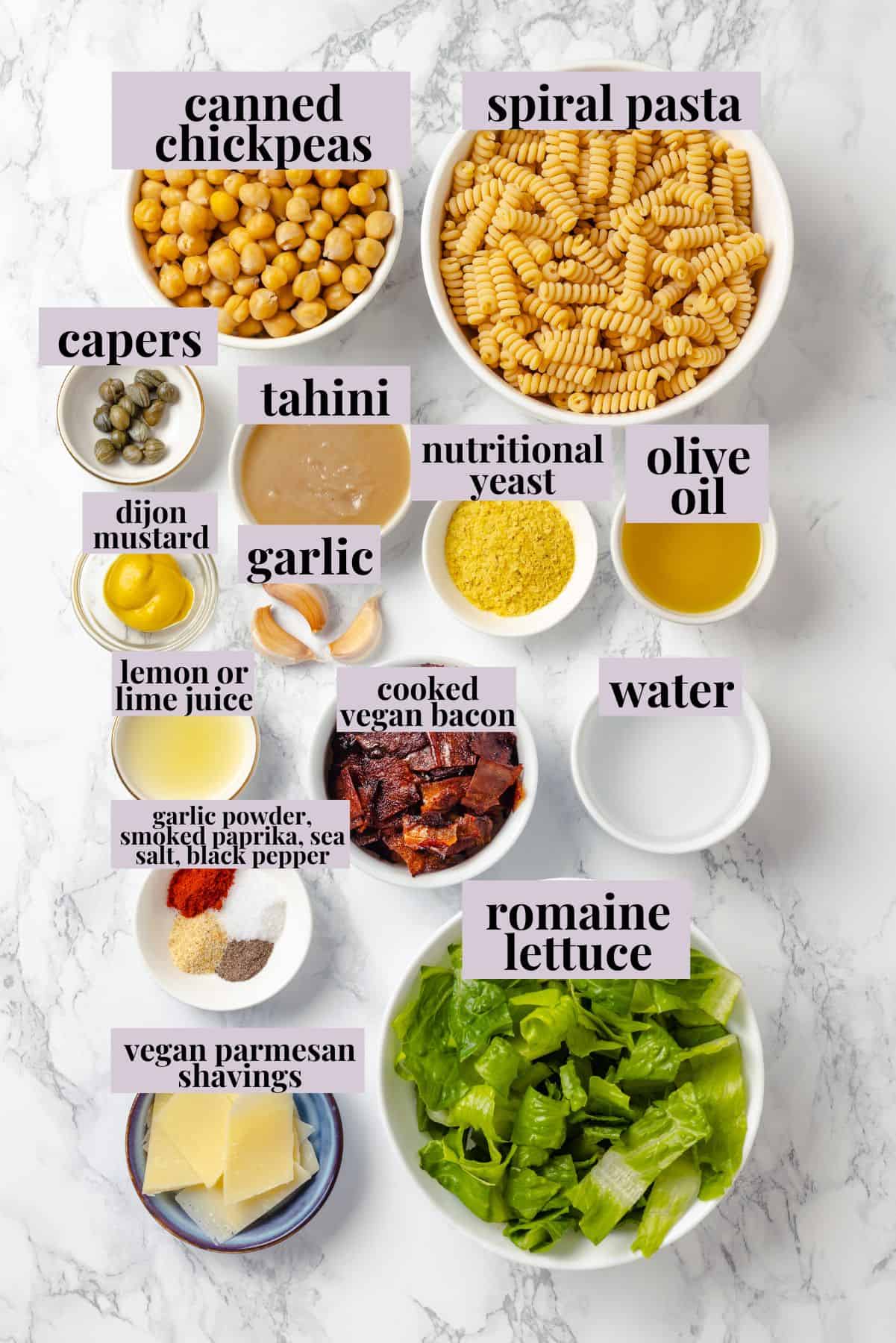 Overhead view of ingredients for caesar pasta salad.
