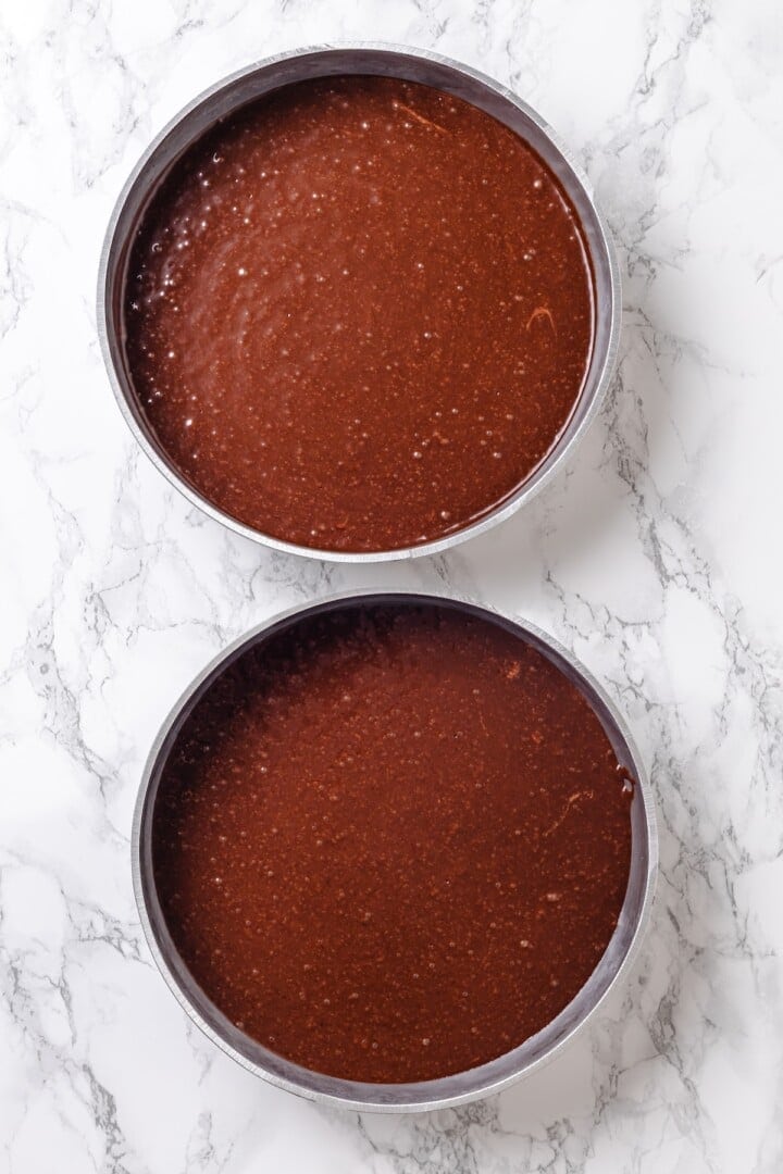 Chocolate cake batter in two pans.