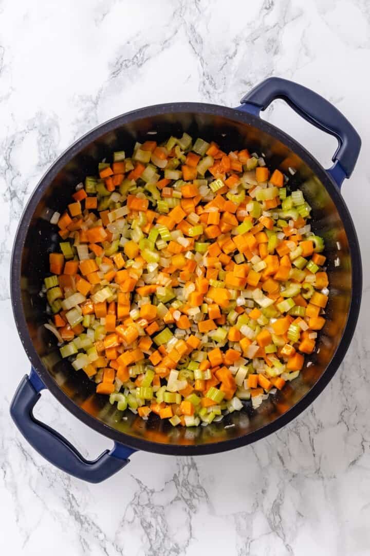 Vegetables sauteing in pan.