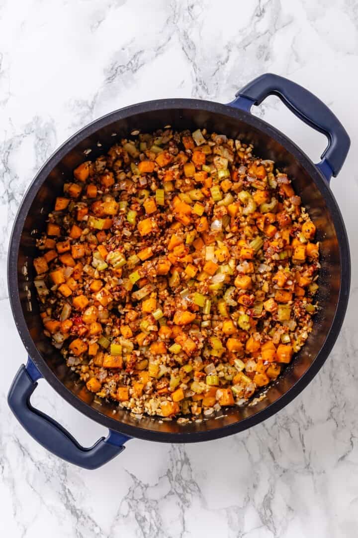 Sauteed vegetables for sauce in pan.