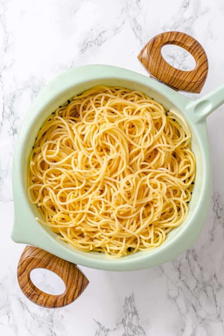 Spaghetti draining in colander.