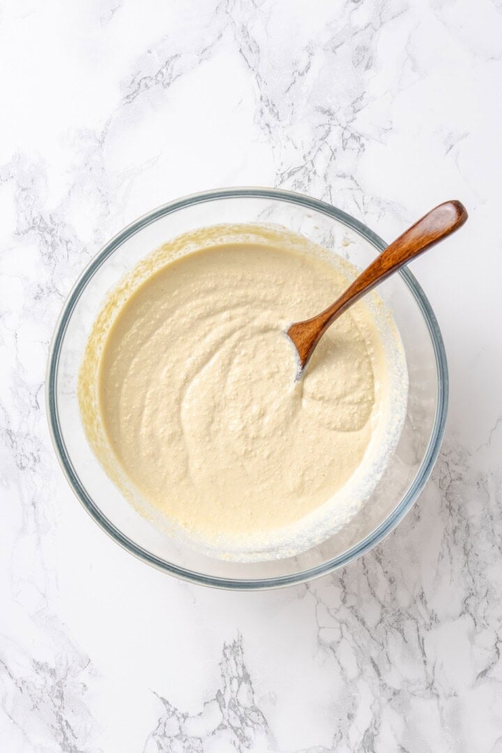RIcotta mixture in glass bowl with wooden spoon.