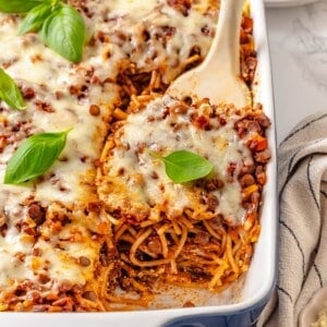 Spatula lifting portion of million dollar spaghetti from pan.